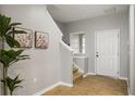 Bright and airy entryway with staircase and neutral wall colors at 2663 River Landing Dr, Sanford, FL 32771