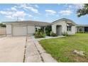 Newly renovated single story home with landscaped front yard at 166 La Paz Dr, Kissimmee, FL 34743