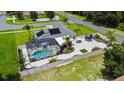 Aerial view of house, fenced backyard, and inground pool at 318 Stone Castle Loop, Lady Lake, FL 32159