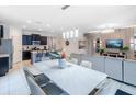 Open concept kitchen and dining area with modern light fixtures at 6047 Broad Oak Dr, Davenport, FL 33837