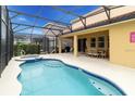 Relaxing pool and spa area with covered patio and lush landscaping at 6047 Broad Oak Dr, Davenport, FL 33837