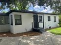 Rear view of a white house with black trim and landscaping at 1639 Silver Star Rd, Orlando, FL 32804