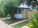 Side view of a white house with black trim and wood fence at 1639 Silver Star Rd, Orlando, FL 32804
