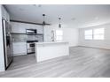 Modern kitchen featuring white shaker cabinets, stainless steel appliances, and a large island at 2070 W Airport Blvd, Sanford, FL 32771