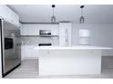 Modern kitchen with white cabinets, stainless steel appliances & an island at 2070 W Airport Blvd, Sanford, FL 32771