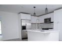 Modern kitchen with white cabinets, island, & stainless steel appliances at 2070 W Airport Blvd, Sanford, FL 32771