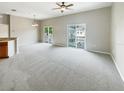 Living room with carpet flooring and sliding glass doors to balcony at 3561 Clay Brick Rd # 47A, Harmony, FL 34773