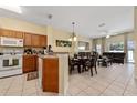 Open concept kitchen with wood cabinets and dining area at 4527 Alberto Cir, Kissimmee, FL 34746