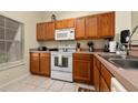 Well-equipped kitchen featuring wood cabinets and appliances at 4527 Alberto Cir, Kissimmee, FL 34746