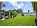 Large backyard with lush green grass and a white fence at 2531 Lyndscape St, Orlando, FL 32833