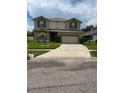 Two-story house with a landscaped yard and attached garage at 2531 Lyndscape St, Orlando, FL 32833