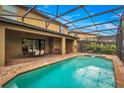 Relaxing pool and spa with seating area under covered patio at 8810 Macapa Dr, Kissimmee, FL 34747