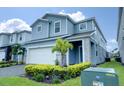 Two-story house with light blue siding, stone accents, and landscaping at 4063 Lana Ave, Davenport, FL 33897