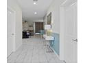 Bright entryway with marble-look tile and contemporary decor at 1158 Drop Ln, Davenport, FL 33896