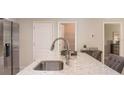 Kitchen island with granite countertop, stainless steel sink and faucet at 218 Great Yarmouth Ct, Kissimmee, FL 34758