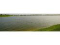 Calm lake view with houses in the background at 4832 Tribute Trl, Kissimmee, FL 34746
