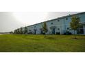 Row of townhouses with neatly landscaped yards and a lake view at 4832 Tribute Trl, Kissimmee, FL 34746