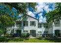 Front view of a two-story townhome with gray siding and landscaping at 4368 S Kirkman Rd # 212, Orlando, FL 32811