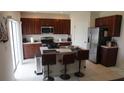 Modern kitchen with stainless steel appliances and an island at 462 Hamlet Loop, Davenport, FL 33837