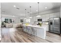 Modern kitchen with island, stainless steel appliances, and white cabinetry at 42 W Harding St # B, Orlando, FL 32806