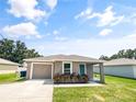 Newly constructed home with a 1-car garage and well-manicured lawn at 888 Old Winter Haven Rd, Auburndale, FL 33823