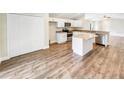 Modern kitchen featuring white cabinets, granite countertops, and stainless steel appliances at 888 Old Winter Haven Rd, Auburndale, FL 33823