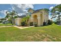 Two-story house with a yellow exterior, attached garage, and landscaping at 2628 Hemingway Ave, Haines City, FL 33844