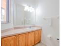 Bathroom with wood cabinets and a large mirror at 1091 Park Ridge Cir, Kissimmee, FL 34746