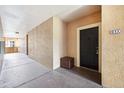 Apartment hallway with a dark door and storage container at 5530 Metrowest Blvd # 9-211, Orlando, FL 32811