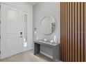 Modern entryway with gray console table and wood accent wall at 5936 High Seas Dr, Orlando, FL 32821