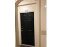 Private condo entrance with a black door and simple design at 6451 Old Park Ln # 110, Orlando, FL 32835