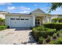 Home with white two-car garage and paver driveway at 4909 W Fountainwood Dr, St Cloud, FL 34772