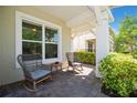 Relaxing front porch with rocking chairs and small table at 4909 W Fountainwood Dr, Saint Cloud, FL 34772