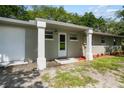 Ranch home with white garage door and entrance at 1406 S Hoagland Blvd, Kissimmee, FL 34746