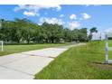 Long driveway leading to a charming house with lush green landscaping at 1406 S Hoagland Blvd, Kissimmee, FL 34746