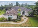 One-story house with tile roof, driveway and lush green lawn at 445 Hightower Dr, Debary, FL 32713