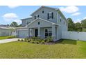 Two-story home with gray siding and landscaped yard at 340 Citrine Loop, Kissimmee, FL 34758