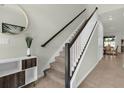 Modern staircase with dark wood railing at 1676 Tropical Palms Cir, Kissimmee, FL 34747