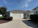 White single car garage with screen door at 1631 Edisto Ln, The Villages, FL 32162