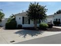 Single-story home with landscaped yard and driveway at 1631 Edisto Ln, The Villages, FL 32162