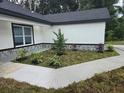 Landscaped front yard with walkway and plants at 14112 Se 34Th Ter, Summerfield, FL 34491