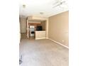 Open living room with carpeted floors and a kitchen with island at 2606 Lodi Cir # 105, Kissimmee, FL 34746