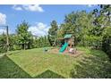 Large backyard with a playground set for  at 1475 Chelsea Manor Cir, Deland, FL 32724