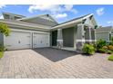 Two-story house with a two-car garage, stone accents, and landscaping at 785 Terrapin Dr, Debary, FL 32713