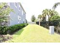 Landscaped side yard with a privacy fence and a spacious lawn area at 1864 Caribbean View Ter, Kissimmee, FL 34747