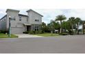 Two-story modern home with stone accents, a landscaped yard, and a gated community at 1864 Caribbean View Ter, Kissimmee, FL 34747