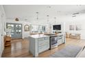 Open concept kitchen with island, stainless steel appliances, and light cabinets at 11130 Park Ave, Windermere, FL 34786