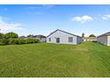 Large backyard with lush green grass and a view of the house's back exterior at 656 Koala Ct, Kissimmee, FL 34759