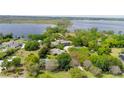 Aerial view of a home showcasing a large lot with a lake view and tennis court at 9726 Kilgore Rd, Orlando, FL 32836