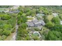 Aerial view of a home with a large pool and tennis court on a spacious lot at 9726 Kilgore Rd, Orlando, FL 32836